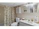 Traditional bathroom featuring a tub with shower, and marble topped vanity with storage at 432 Moorings Cove Dr. # 432, Tarpon Springs, FL 34689