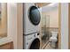 Bathroom with a walk-in shower, toilet and stackable washer and dryer units at 432 Moorings Cove Dr. # 432, Tarpon Springs, FL 34689