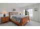 Cozy bedroom with a large window featuring a comfortable bed with decorative pillows and lamps at 432 Moorings Cove Dr. # 432, Tarpon Springs, FL 34689