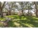 Beautiful community green space with mature trees, seating, and kayak storage at 432 Moorings Cove Dr. # 432, Tarpon Springs, FL 34689