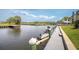 Water view from private dock with boat and jet ski parking on a sunny day at 432 Moorings Cove Dr. # 432, Tarpon Springs, FL 34689