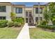 Charming condo exterior with well-maintained landscaping and easy access to units at 432 Moorings Cove Dr. # 432, Tarpon Springs, FL 34689