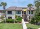 Inviting two-story condo with tropical landscaping and accessible entrance for convenient access at 432 Moorings Cove Dr. # 432, Tarpon Springs, FL 34689