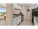 Bright kitchen featuring white cabinetry, stainless steel appliances, and a lovely view at 432 Moorings Cove Dr. # 432, Tarpon Springs, FL 34689