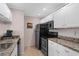 Modern kitchen featuring stainless steel appliances, white cabinetry, and light countertops at 432 Moorings Cove Dr. # 432, Tarpon Springs, FL 34689