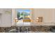 Kitchen counter overlooking eat-in-kitchen, with a large window offering lake views at 432 Moorings Cove Dr. # 432, Tarpon Springs, FL 34689