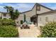 Outdoor patio with a picnic table, an umbrella, a grill, and landscaping at 432 Moorings Cove Dr. # 432, Tarpon Springs, FL 34689