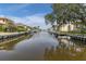 Beautiful canal view lined with homes, docks, and boats on a sunny day at 432 Moorings Cove Dr. # 432, Tarpon Springs, FL 34689