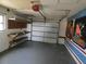 Attached garage with storage shelf and door at 4451 Higate Rd, Spring Hill, FL 34609