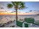 Benches overlooking a serene beach and ocean at sunset at 4452 Garnet Dr # 101, New Port Richey, FL 34652