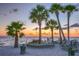 Ocean sunset views with palm trees and a waterfront bench at 4452 Garnet Dr # 101, New Port Richey, FL 34652