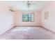 Bright bedroom featuring a large window and light pink walls and carpet at 4529 Flounder Dr, Hernando Beach, FL 34607