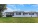 Exterior view of the home with a screened-in porch, offering a comfortable outdoor space at 5122 Bonito Dr, New Port Richey, FL 34652