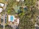 Community amenities featuring a pool, clubhouse, tennis courts, and ample parking amid mature trees at 6002 Laketree Ln # L, Temple Terrace, FL 33617