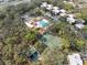 Aerial view of community amenities including a pool, clubhouse, and tennis courts surrounded by apartments at 6002 Laketree Ln # L, Temple Terrace, FL 33617