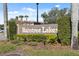 Raintree Lakes community sign surrounded by lush landscaping and mature trees at 6002 Laketree Ln # L, Temple Terrace, FL 33617
