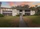Inviting exterior view of the condo building with well-maintained lawn and landscaping at 6002 Laketree Ln # L, Temple Terrace, FL 33617