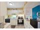 Cozy kitchen features white cabinets, stainless steel appliances, and an abundance of counter space at 6002 Laketree Ln # L, Temple Terrace, FL 33617