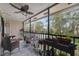 Screened patio with ceiling fan and serene backyard views at 6002 Laketree Ln # L, Temple Terrace, FL 33617