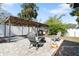 View of outdoor covered barbeque and patio area with chairs and a fire pit on a brick base at 6305 S Macdill Ave, Tampa, FL 33611