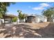 View of the backyard with a covered patio and barbeque area, seating, and new grass at 6305 S Macdill Ave, Tampa, FL 33611