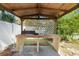 Close up of a brick barbeque with a lattice backing under an open wooden patio structure at 6305 S Macdill Ave, Tampa, FL 33611