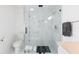 Modern bathroom with marble tiled shower, updated toilet, and modern fixtures at 6305 S Macdill Ave, Tampa, FL 33611