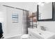 Bathroom with tub, toilet, metal shelving and small window for natural light at 6305 S Macdill Ave, Tampa, FL 33611