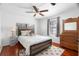 Cozy bedroom with a comfortable bed, hardwood floors, and a dresser at 6305 S Macdill Ave, Tampa, FL 33611