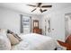 Cozy bedroom with a ceiling fan, wood dresser, and large window for ample natural light at 6305 S Macdill Ave, Tampa, FL 33611