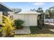 Exterior view of the attached shed with a new door and an adjacent covered porch area at 6305 S Macdill Ave, Tampa, FL 33611