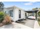 Well-kept home with a convenient carport, black-framed windows and a black front door at 6305 S Macdill Ave, Tampa, FL 33611