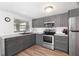 Renovated kitchen with stainless steel appliances and gray cabinets at 6305 S Macdill Ave, Tampa, FL 33611