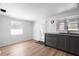 Well-lit eat-in kitchen with gray cabinets and stainless steel sink at 6305 S Macdill Ave, Tampa, FL 33611