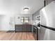 Updated kitchen featuring modern appliances, gray cabinetry, and ample counter space at 6305 S Macdill Ave, Tampa, FL 33611