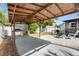 Outdoor kitchen with a brick barbeque under a covered patio overlooking the open backyard area at 6305 S Macdill Ave, Tampa, FL 33611