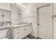 Bright bathroom with a granite countertop vanity, stylish lighting, and a modern gray floor at 6734 Dali Ave # 205, Land O Lakes, FL 34637