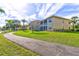 Beautiful two-story condo buildings with screened patios and landscaped grounds along walking path at 6734 Dali Ave # 205, Land O Lakes, FL 34637