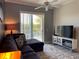 Cozy living room featuring plush furniture and a scenic view of the lake from the balcony at 6734 Dali Ave # 205, Land O Lakes, FL 34637