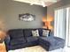 Comfortable living room showcasing a modern couch and a decorative rug at 6734 Dali Ave # 205, Land O Lakes, FL 34637