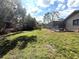 A partially wooded backyard with a shed and pool; a perfect setting for entertainment or relaxation at 7090 Red Oak Loop, New Port Richey, FL 34654