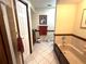 Neutral-toned bathroom with soaking tub, tiled floor, and dark wood trim throughout at 7090 Red Oak Loop, New Port Richey, FL 34654