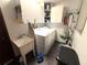 Laundry room with washer, dryer, sink, and storage cabinets to keep your cleaning supplies organized and hidden at 7090 Red Oak Loop, New Port Richey, FL 34654