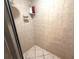 Tiled shower stall featuring built-in soap dish and corner shelving for toiletries at 7090 Red Oak Loop, New Port Richey, FL 34654