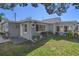 Home with a well-maintained lawn, side patio, and landscaped garden bed along the side of the home at 7235 Maryland Ave, Hudson, FL 34667