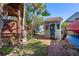 Charming backyard with a landscaped path and quaint outdoor bathroom, perfect for outdoor living at 7235 Maryland Ave, Hudson, FL 34667