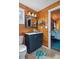 Cozy bathroom with wood-clad walls, an undermount sink and views into the primary bedroom at 7235 Maryland Ave, Hudson, FL 34667