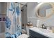 Bright bathroom featuring a vanity sink, bathtub, and stylish nautical-themed shower curtain at 7235 Maryland Ave, Hudson, FL 34667
