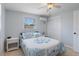 Comfortable guest bedroom with blue and white bedding, tile flooring and sliding door closet at 7235 Maryland Ave, Hudson, FL 34667