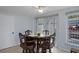 A charming dining area with a decorative table for four, complemented by large windows and neutral decor at 7235 Maryland Ave, Hudson, FL 34667